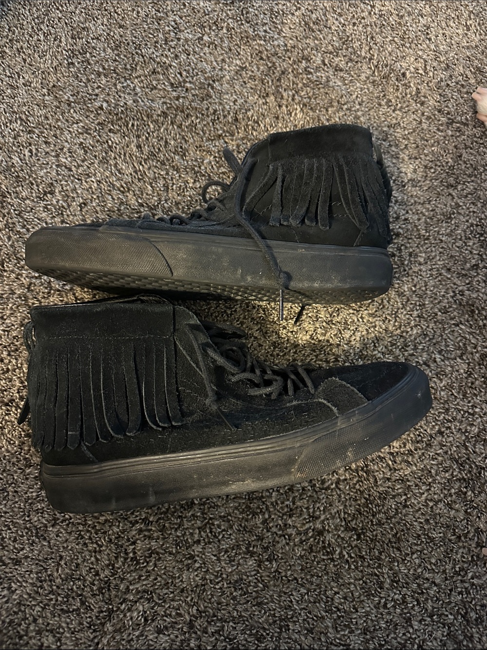 Black Vans sneakers with fringe